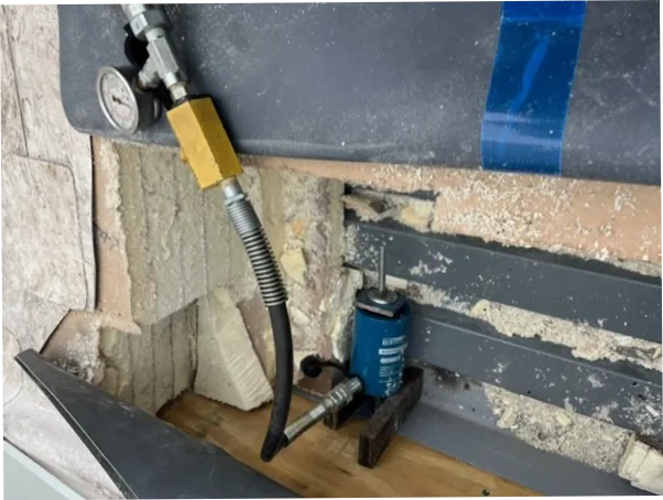 Enerpac center-hole hydraulic cylinder mounted on bridge plate during anchor bolt pull test