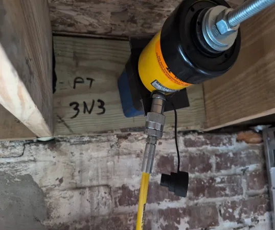 Overhead anchor bolt pull test on post-tensioned concrete slab